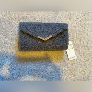 Gray clutch with gold finishing and long strap